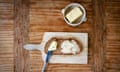 Butter and bread on a chopping board.