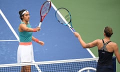 Karolina Pliskova (right) touches rackets with Caroline Garcia after the French player’s win on the empty Louis Armstrong court.