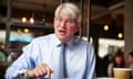 Andrew Mitchell, speaking and gesticulating in conversation during the Conservative party’s annual conference, with a paper coffee cup at his side