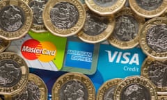 Mastercard, American Express and Visa credit cards with UK one pound coins