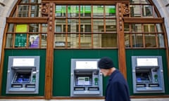 Man walking past ATM machines