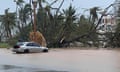 The Hagatna River overflows its banks and encroaches into the Bank of Guam parking lot in Hagatna, Guam, on Thursday in the wake of Typhoon Mawar