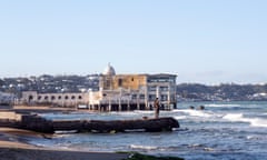 A couple stand on a spit on the seafront at La Marsa, a popular tourist resort in Tunis, Tunisia.