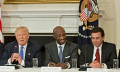 Three men in suits sitting at a table