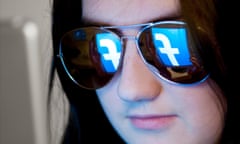 Facebook logo reflected in glasses.