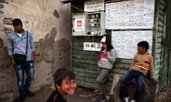 A young girl charges a mobile phone at the former first reception centre near to the port of Chios, where refugees and migrants were camping out.