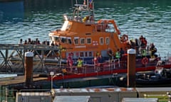 People thought to be asylum seekers arriving at Dover on the Dover lifeboat after being picked up in the Channel earlier today.