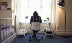 Female Student Sitting At Desk And Working In Bedroom