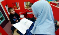 THOMOND -  Gladys Rhodes , head of early years excellence children's trust, at the Audley and Queens Park Community Centre library in Blackburn with two children.     
Guardian Society.  18/11/2004.    CHRISTOPHER THOMOND.
No syndication. Repro fees apply