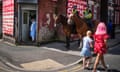 People walk past two mounted police officers