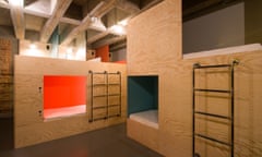 Plywood walls with gaps and ladders to cubbyhole beds