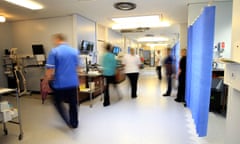 Blurry figures walking in a hospital ward