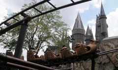 Guests ride on the Flight of the Hippogriff past Hogwarts castle at the Universal Studios Wizarding World of Harry Potter theme park in Orlando, Florida.