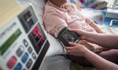 A generic bedside blood-pressure check on a patient by a nurse