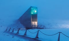 The entrance to the Svalbard Global Seed Vault is a tall metal rectangle set into a snowy mountainside.