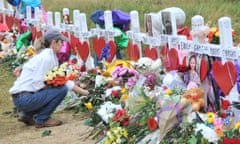 A woman lays flowers at a memorial site for victims of the shooting in Sutherland Springs, Texas