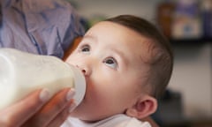 Baby girl drinking from a bottle of milk