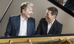 Yves Thibaudet and Michael Feinstein seated at a grand piano together, smiling