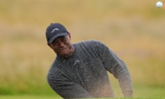 Tiger Woods plays out from a bunker on the 16th hole