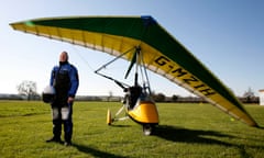 Nigel in safety gear with his microlight, on a grassy field.