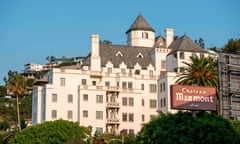 A large white hotel built in the style of a French chateau sits on a hillside in Los Angeles.