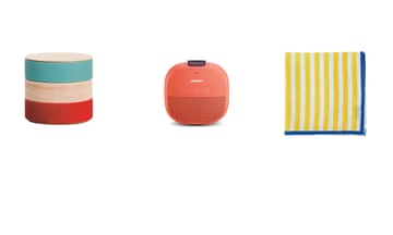 Stacking Japanese food boxes, orange Bose speaker and stripy linen napkin