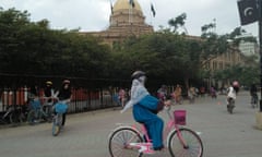 Girls cycle outside Karachi’s colonial-era Custom House.