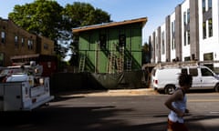 a green house being built and a jogger running past