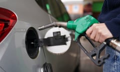 a motorist fills up their car fuel tank