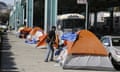 A man stand outside his tent on Division Street Tuesday, Feb. 23, 2016, in San Francisco. San Francisco health officials declared a tent city that has been growing along a city street a health hazard and gave homeless people living on the sidewalk 72 hours to clear the area. The Department of Public Health said notices declaring the area along Division Street a public nuisance and encouraging homeless people to move to city shelters would be posted Tuesday. (AP Photo/Eric Risberg)