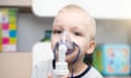 Child inhaling via a mask on his face.