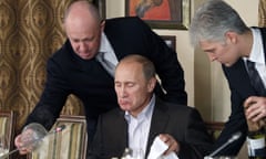 Vladimir Putin, Yevgeny Prigozhin<br>FILE - In this Friday, Nov. 11, 2011 file photo, businessman Yevgeny Prigozhin, left, serves food to Russian Prime Minister Vladimir Putin, center, during dinner at Prigozhin's restaurant outside Moscow, Russia.  Indicted for alleged U.S. election interference, Prigozhin is a wealthy Russian entrepreneur from St. Petersburg who's been dubbed "Putin's chef" by Russian media, with his catering businesses that have hosted the Kremlin leader's dinners with foreign dignitaries. (AP Photo/Misha Japaridze, Pool, File)