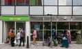 People queue to enter a job centre in east London.