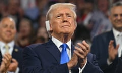 With his ear bandaged, the former president Donald Trump applauds at the Republican national convention