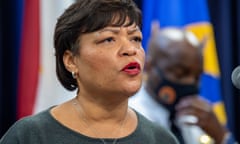 A woman speaks into a microphone at a press conference