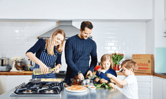 man, women and children cooking