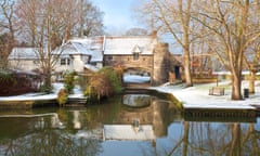 Pulls Ferry, once a 15th Century watergate, on the River Wensum following winter snowfall. A canal used to run under the arch al<br>CET3RN Pulls Ferry, once a 15th Century watergate, on the River Wensum following winter snowfall. A canal used to run under the arch al