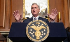 Kevin McCarthy stands behind a podium marked with the seal of the US House of Representatives speaker.