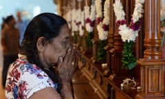 A woman prays at a church in Sri Lanka targeted in bombings on Easter Sunday