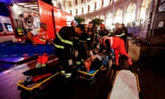 First responders evacuate a wounded person from Piazza della Repubblica in central Rome