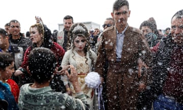 Iraqi newlyweds who fled Mosul, Hussain Zeeno Zannun, 26, and Chahad, 16, are showered in foam during their wedding party at Khazer camp<br>Iraqi newlyweds, who fled Mosul, Hussain Zeeno Zannun (R) 26, and Chahad, 16, are showered in foam during their wedding party at Khazer camp in Iraq February 16, 2017. REUTERS/Zohra Bensemra