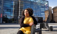 Furaha Asani sitting on bench outside modern   Leicester university building