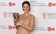 Phoebe Waller-Bridge with her Bafta award, wearing the 50:50 badge as a ring