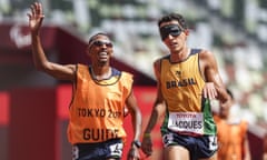 Brazil’s Yeltsin and his guide celebrate his win in the 5000m (T11). 