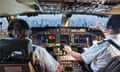 two people in plane cockpit overlooking cityscape