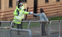 NHS staff hand out test kits to Glasgow University students at a test centre at the Murano Street student village