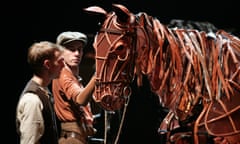 Toby Olié controls a puppet in War Horse.