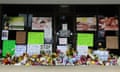 Flowers, candles and signs lie at a makeshift memorial outside Young’s Asian Massage in Acworth, Georgia.