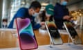 People look at i-Phone 14 models at an Apple store at a mall in Beijing