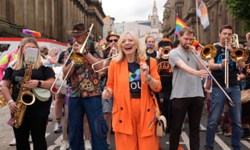 Tracy Brabin laughs as she walks alongside people playing brass instruments